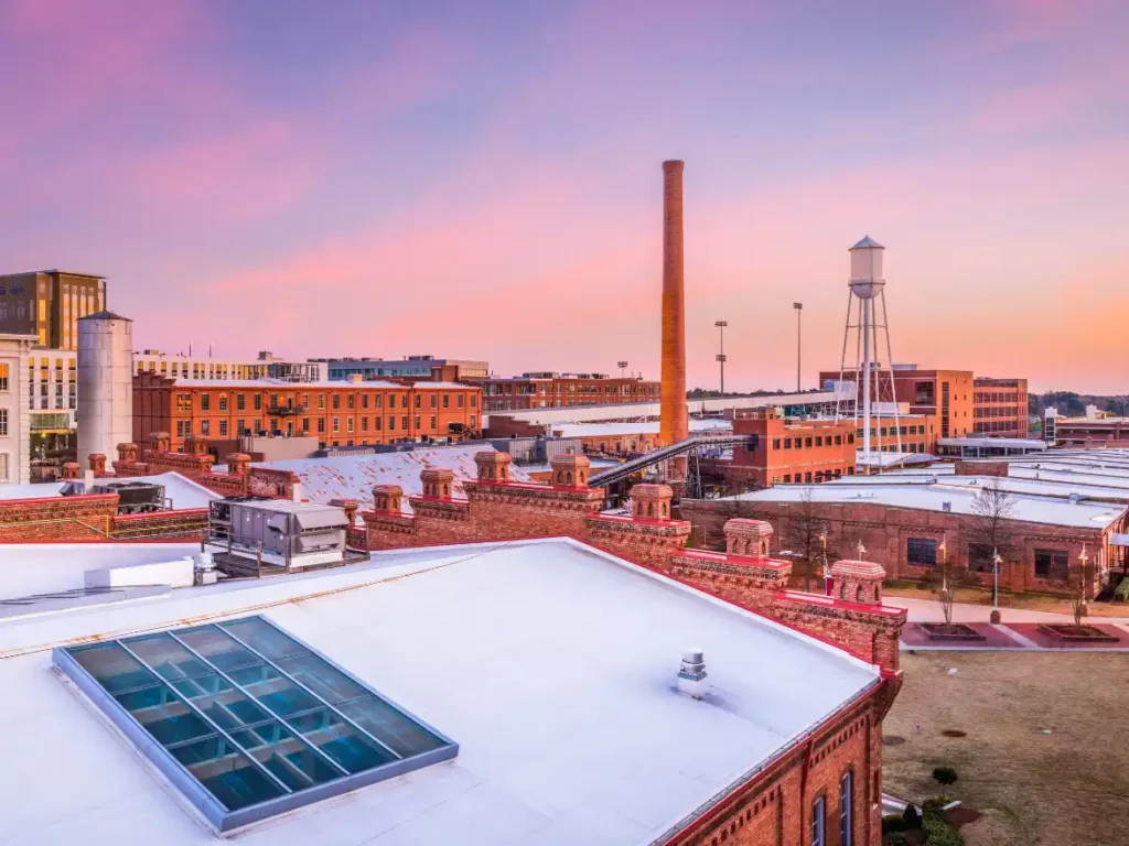 Downtown Durham, NC skyline at dusk with historic and modern office buildings