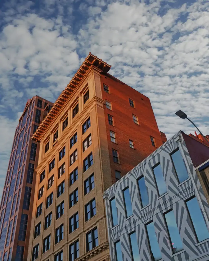Historic brick building in downtown Raleigh, NC against a cloudy sky
