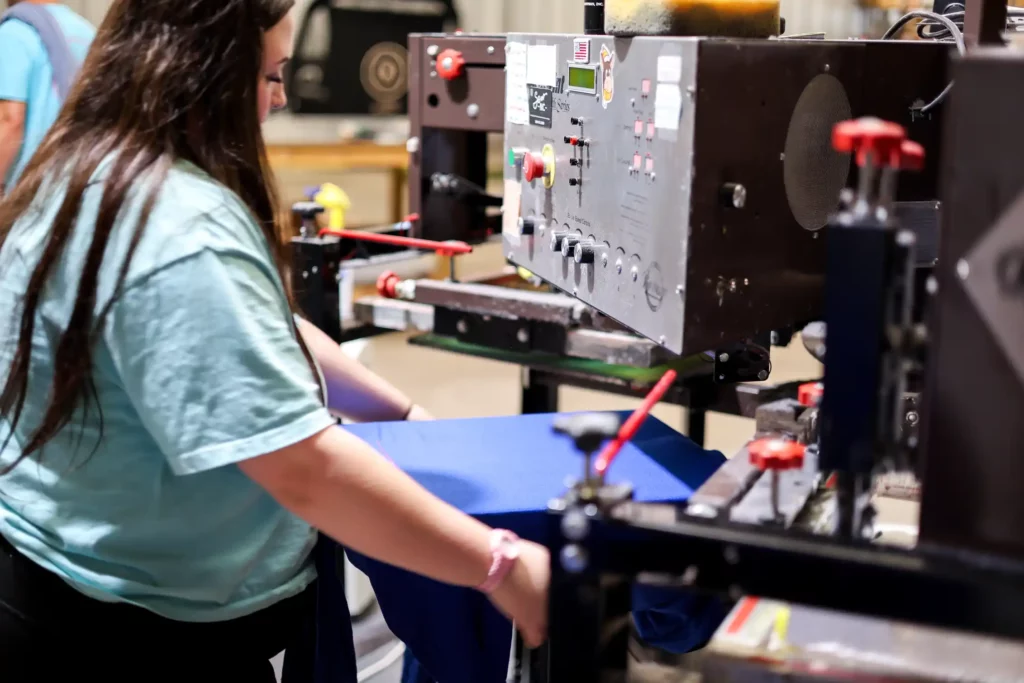 loading-blue-hoodie-onto-screen-printing-press