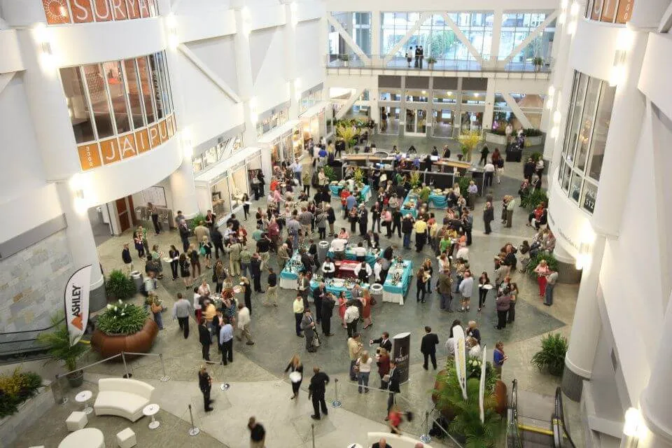 Buyers and exhibitors filling a showroom atrium during High Point furniture market week